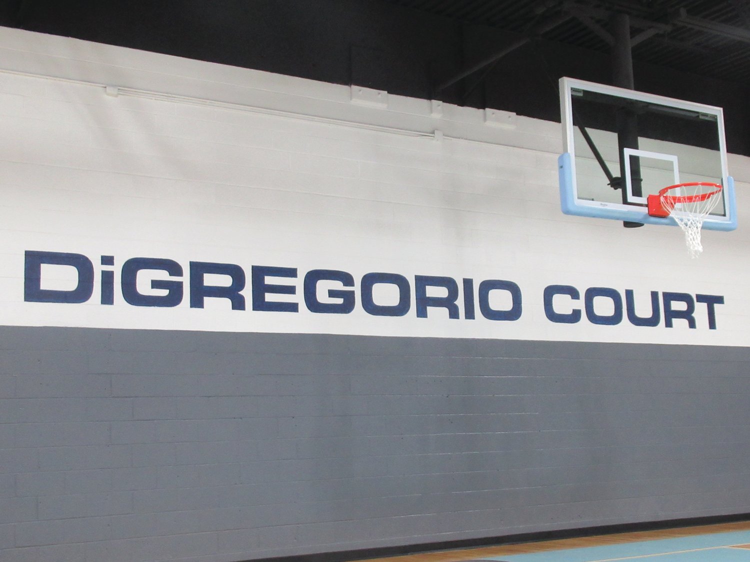 AWESOME APPRECIAITON: The new and shiny basketball court inside Rainone Gym is officially named the “DiGregorio Court” in honor of the countless contributions and money Rico DiGregorio and his company put into the project.